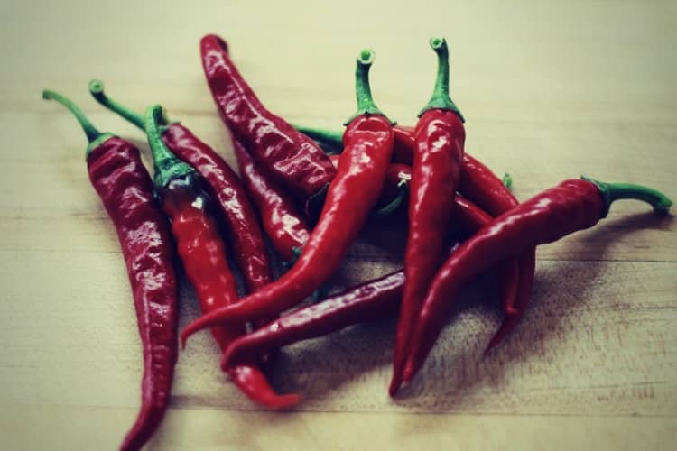 Assorted red hot peppers on a cutting board