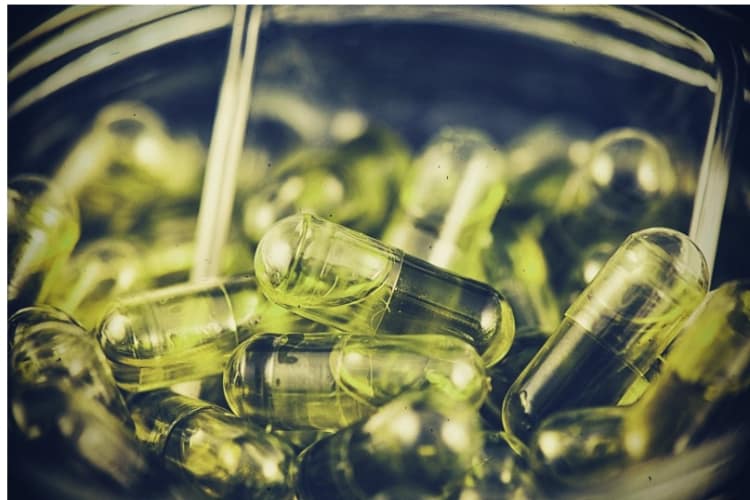 Cannabis extraction capsules infused with CBD oil in a jar Cannabis extraction capsules infused with CBD oil in a jar