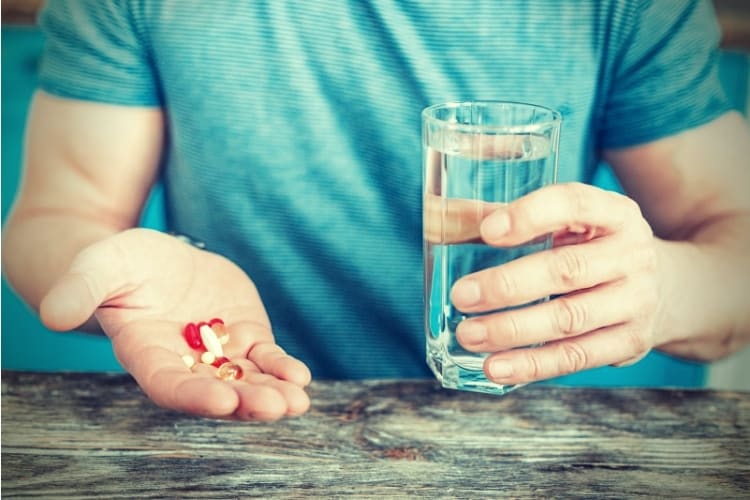 Colorful helpful drugs being in mans hand