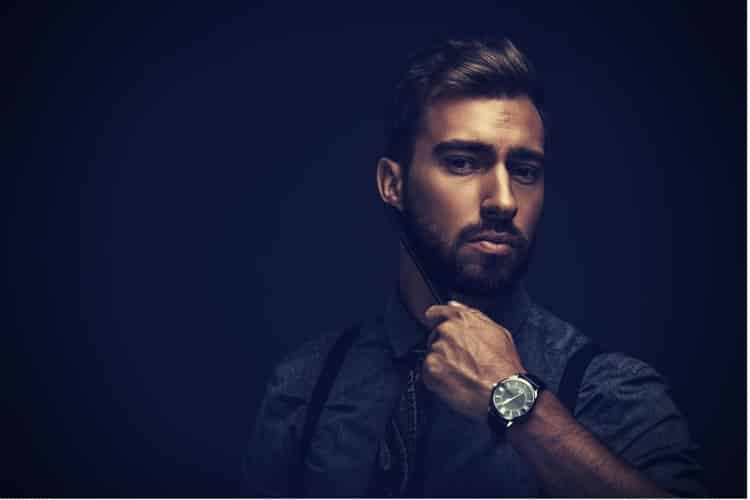 Handsome man combing beard Handsome man combing beard