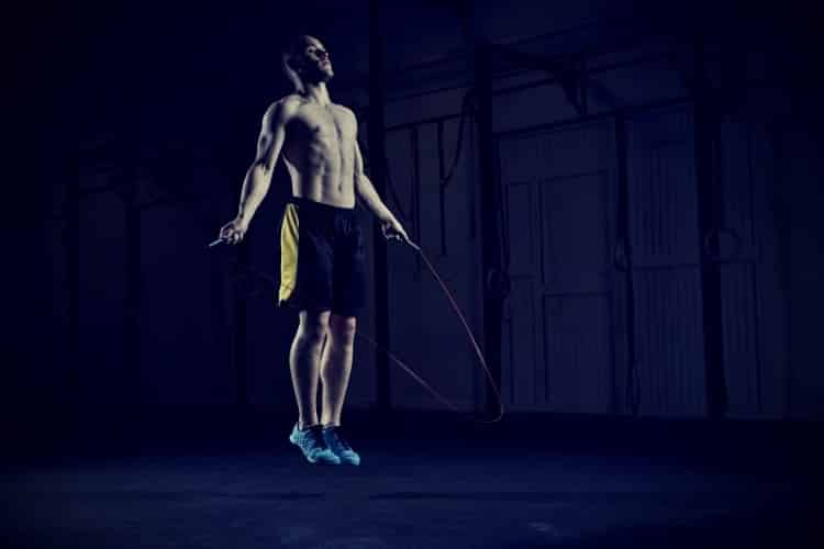 Male athlete skipping rope