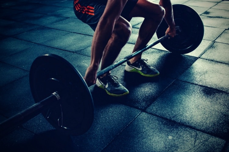 Person holding barbell Person holding barbell