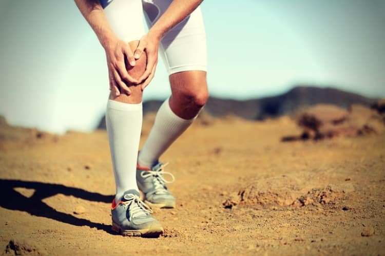 Running injury - male runner with knee pain Running injury - male runner with knee pain
