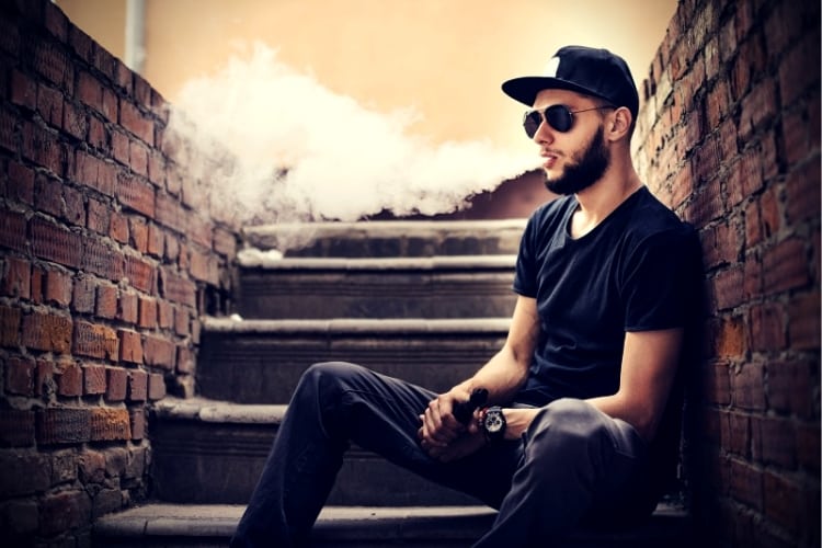 Vaper with beard in sunglasses