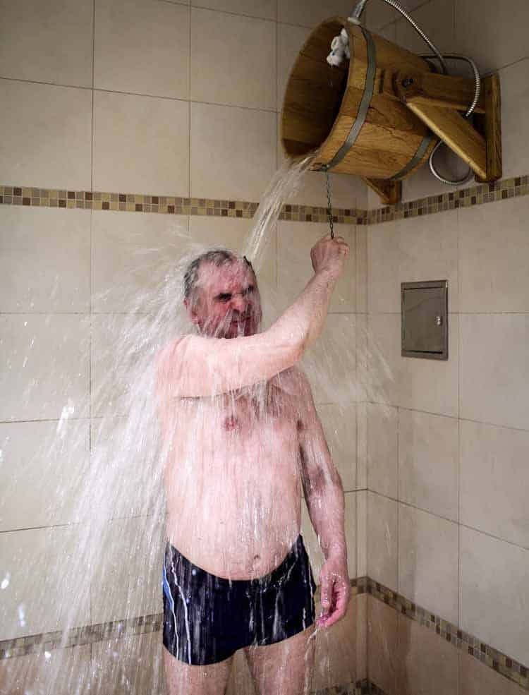 Man taking a cold shower for testosterone and recovery