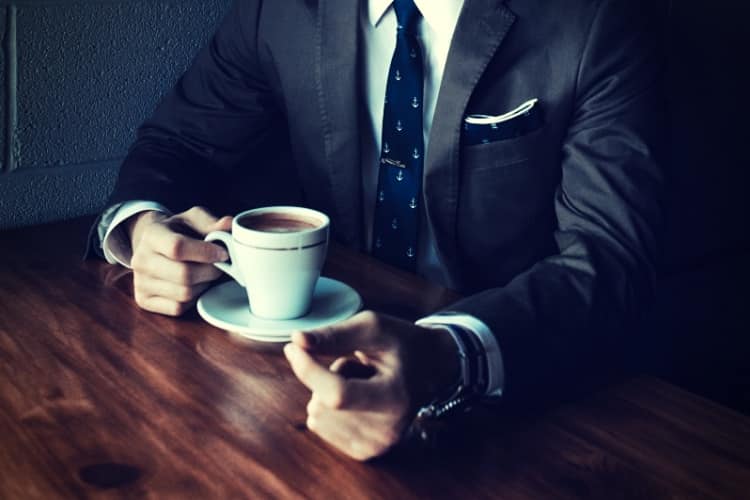 man holding cup filled with coffee