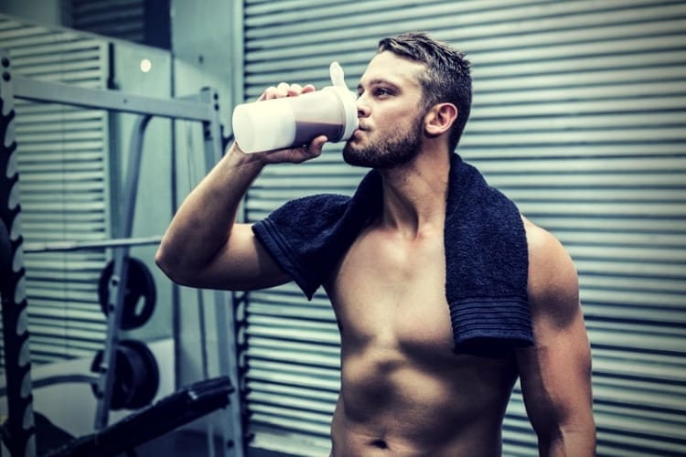 muscular man drinking protein cocktail muscular man drinking protein cocktail